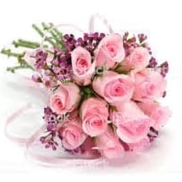Bouquet of pink roses with purple filler flowers tied with a pink ribbon