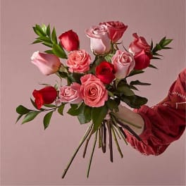 Handheld bouquet of pink and red roses