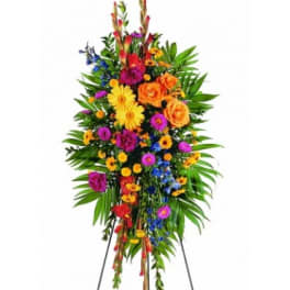 Tall standing floral spray with bright mixed flowers on an easel