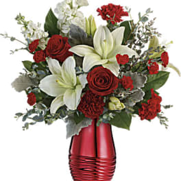 Red roses and white lilies in a red vase