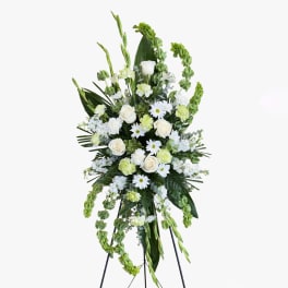 Tall white and green floral standing spray on an easel