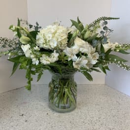 White floral arrangement in a clear glass vase
