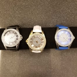 Three jeweled wristwatches with black, white, and blue bands