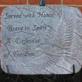 Memorial stone plaque with an eagle relief and engraved text