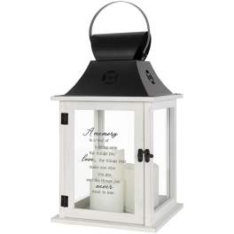 White lantern with black top and candles inside