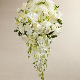 White cascading bridal bouquet with lilies, roses, and orchids
