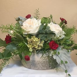 White roses and red carnations in a glittery silver container