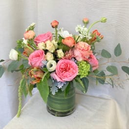 Pink and peach rose bouquet in a glass vase