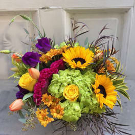 Bright mixed bouquet with sunflowers, roses, and purple blooms