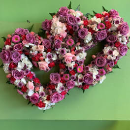 Heart-shaped floral wreath with purple roses and pink-white blooms