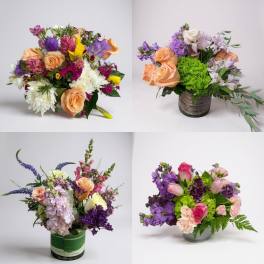 Four colorful mixed flower arrangements in vases and containers