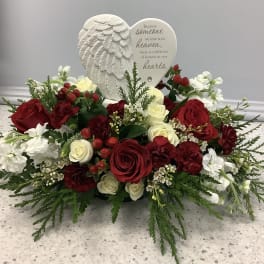 Heart-shaped sympathy arrangement with red and white roses and a memorial plaque