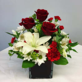Red roses and white lilies in a black vase