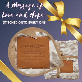 Fur-textured blanket with an embroidered "Amazing Grace" patch and gold ribbon