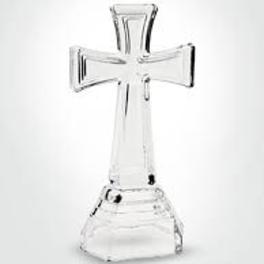 Clear glass cross-shaped candle holder on a white background