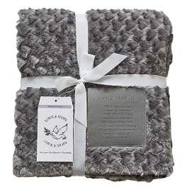 Gray plush blanket tied with a white ribbon and sympathy tags