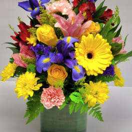 Colorful mixed bouquet in a green square vase