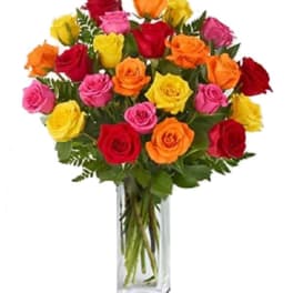 Bouquet of multicolored roses in a clear glass vase