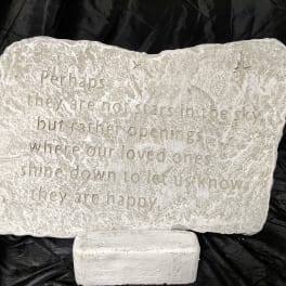 Engraved memorial stone with a quote on a stand
