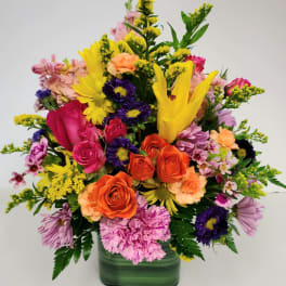 Colorful mixed bouquet in a green glass vase