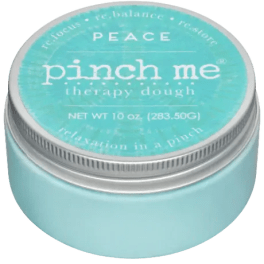 A turquoise jar labeled "pinch me therapy dough" with a silver lid
