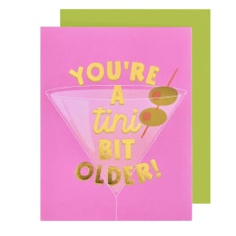 Pink birthday card with a martini glass and gold text