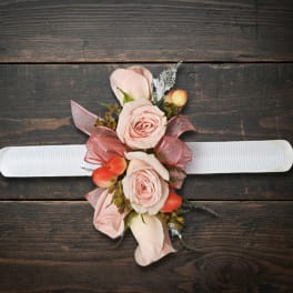 Blush pink rose wrist corsage with berries on a white band