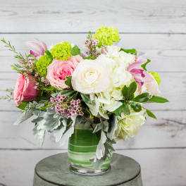 Pink and white mixed flower arrangement in a glass vase