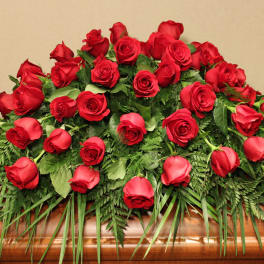 Casket spray of red roses with greenery