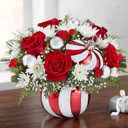 Red roses and white daisies in a striped ornament vase