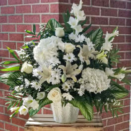 White floral standing spray in a white vase