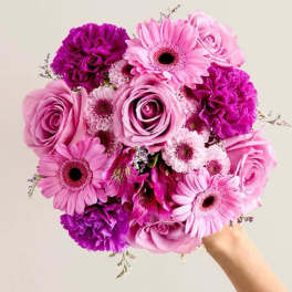 Pink and purple bouquet with roses, gerbera daisies, and carnations