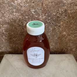 Bottle of honey with a white cap and label