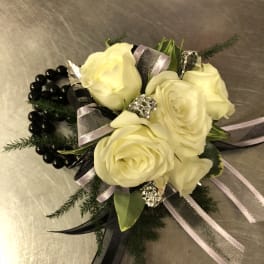 Cream rose corsage with black beads and silver ribbon