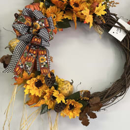 Fall wreath with sunflowers, pumpkins, and a plaid bow