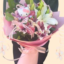 Pink and white lily bouquet with a Hello Kitty plush and ribbon wrap