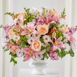 Pink lilies and peach roses in a white vase