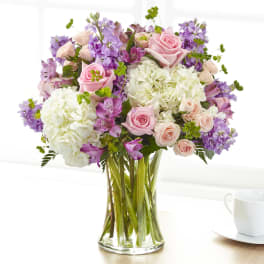 Pink roses and white hydrangeas in a clear glass vase