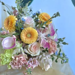 Bouquet of yellow gerbera daisies, pink roses, and calla lilies