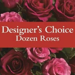 Dozen roses in shades of pink and red with a text banner across the center