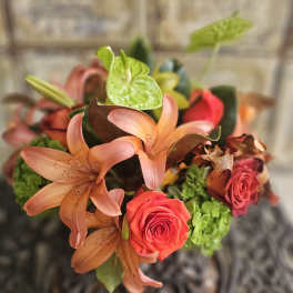 Bouquet of peach lilies, red roses, and green anthuriums