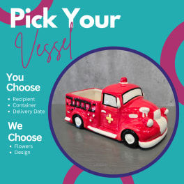 Red ceramic truck-shaped planter on a gray surface