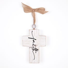White wooden cross ornament with a tan bow and black script