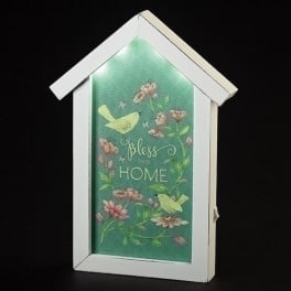 House-shaped wall decor with birds, flowers, and the words "Bless this home"