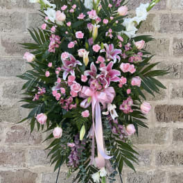 Tall pink and white floral standing spray with lilies and roses