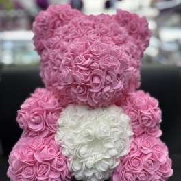 Pink and white teddy bear made of small rose-like flowers