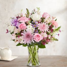 Pink and white mixed bouquet in a clear glass vase