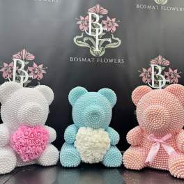 Three pearl-covered teddy bears with floral hearts in pink, white, and blue.