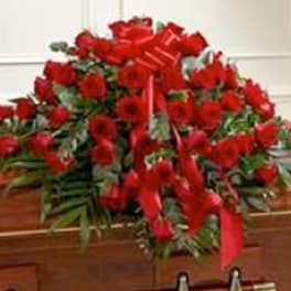 Large arrangement of red roses with a red ribbon