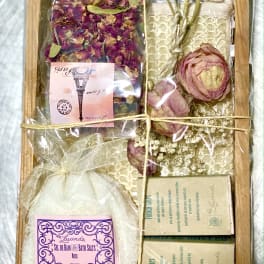 Gift box with dried flower petals, bath salts, and soap bars